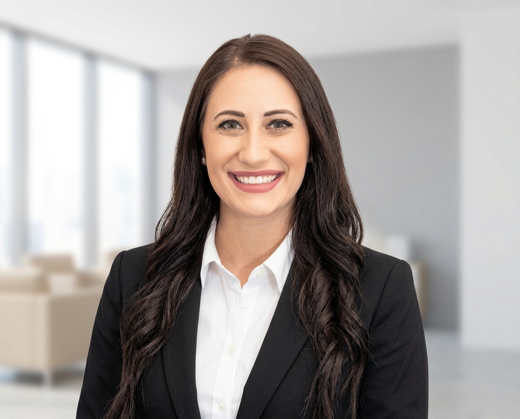 Tech employee headshot in a bright modern office, one locked company style