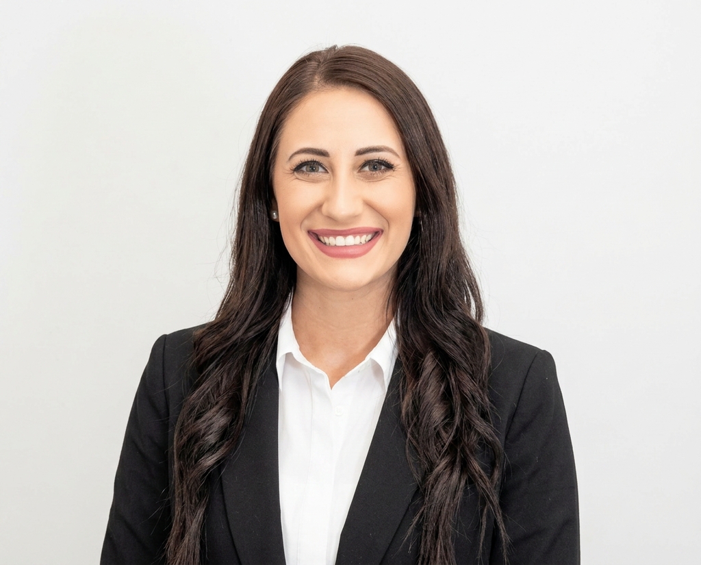 Tech employee headshot on a clean neutral studio backdrop, one locked company style