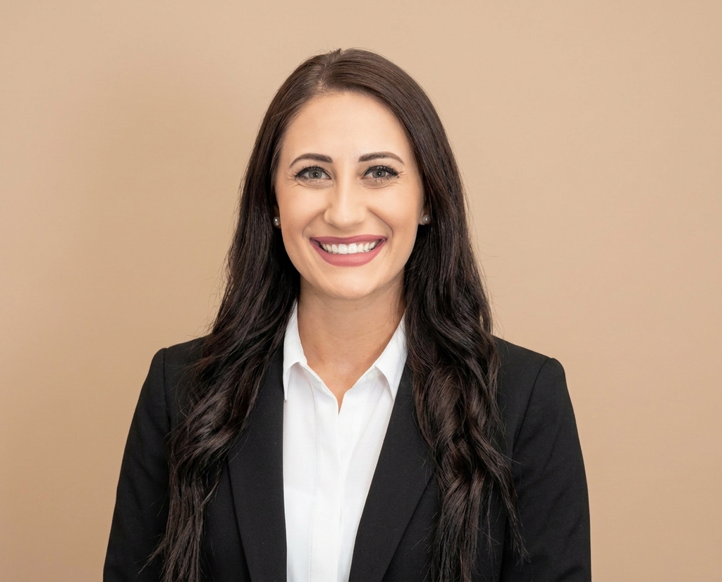 Sales rep headshot on a solid warm-tone studio backdrop