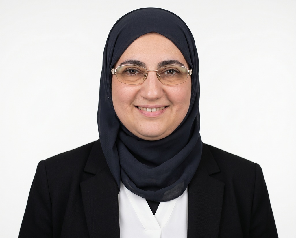 Mariam's headshot, white studio backdrop
